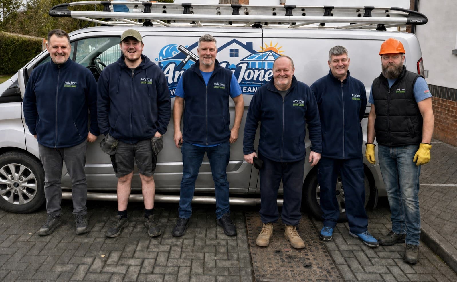 The Andy Jones Window Cleaning team standing beside a branded van
